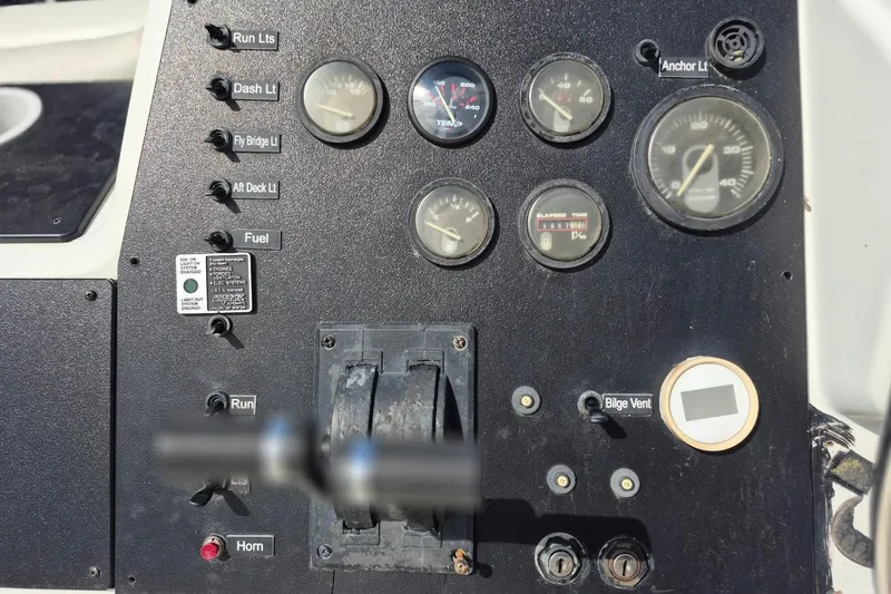 Slide: The Image of Control panel of a 1991 Carver 36 Aft Cabin Motor Yacht with gauges and switches. - 11