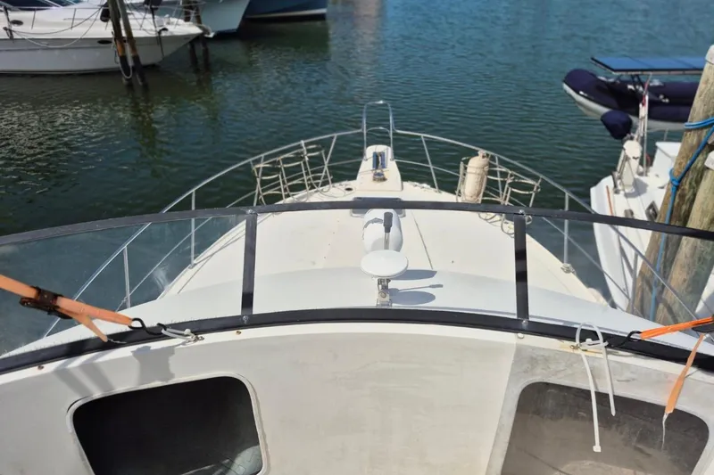 Slide: The Image of 1991 Carver 36 Aft Cabin Motor Yacht docked at marina, view from bow. - 14