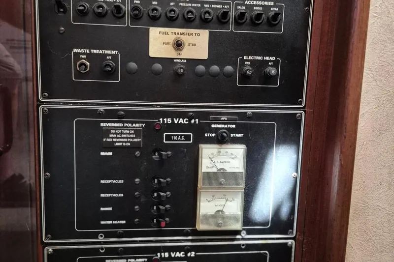Slide: The Image of Control panel of a 1991 Carver 36 Aft Cabin Motor Yacht, featuring various switches and gauges. - 17
