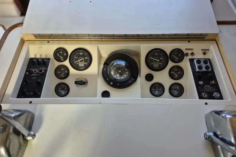 Slide: The Image of Control panel of a 1991 Carver 36 Aft Cabin Motor Yacht with gauges and switches. - 18