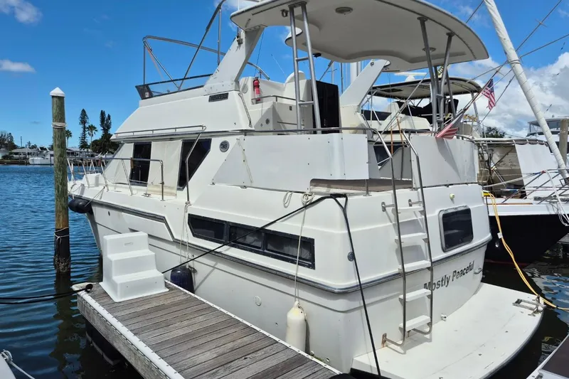 Slide: The Image of 1991 Carver 36 Aft Cabin Motor Yacht docked at marina, clear sky background. - 3