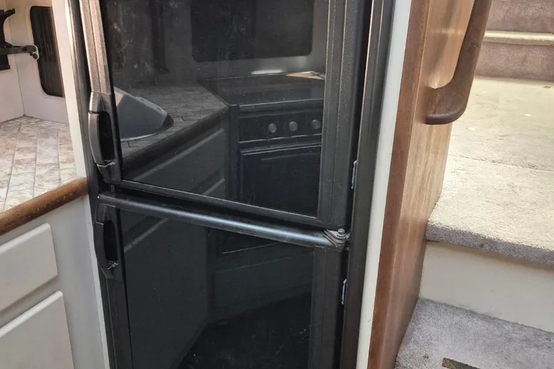 Slide: The Image of 1991 Carver 36 Aft Cabin Motor Yacht interior with refrigerator and stairs. - 30