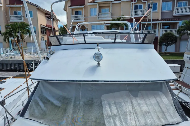 Slide: The Image of 1991 Carver 36 Aft Cabin Motor Yacht docked near waterfront homes. - 5