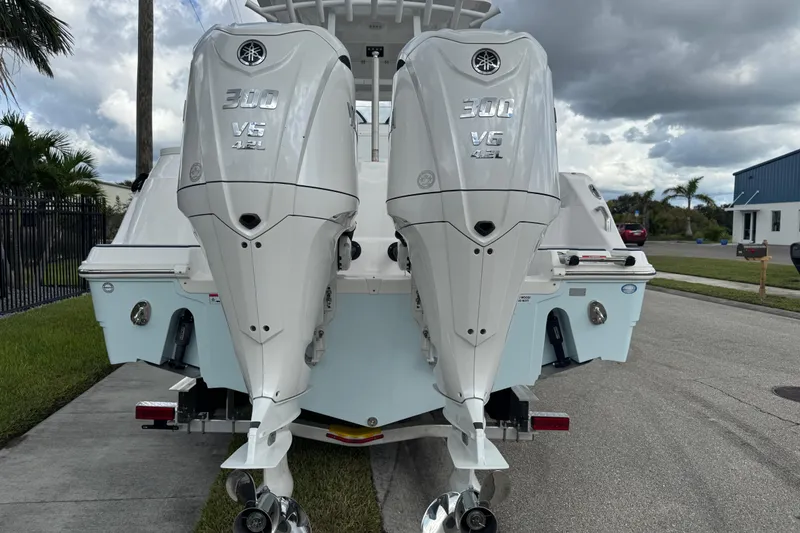 Slide: The Image of 2025 Sea Fox 288 Commander with twin Yamaha 300 V6 outboard engines, parked on a street. - 10