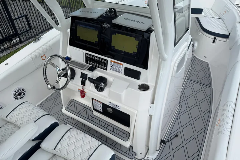 Slide: The Image of 2025 Sea Fox 288 Commander boat cockpit with dual Garmin displays and luxury seating. - 130