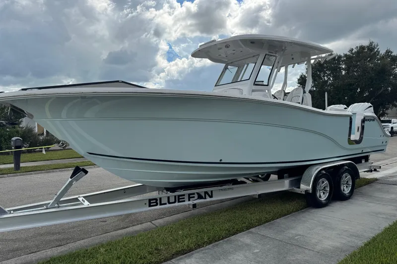 Slide: The Image of 2025 Sea Fox 288 Commander boat on trailer, parked on suburban street. - 25