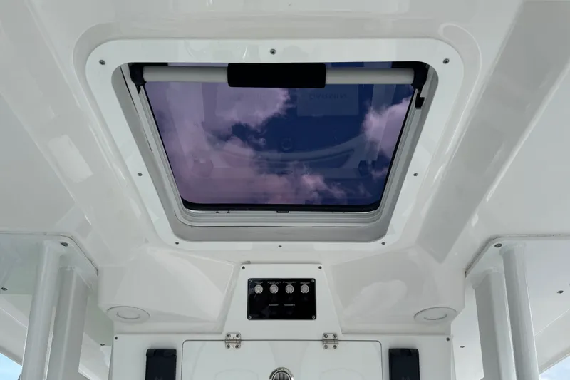 Slide: The Image of 2025 Sea Fox 288 Commander boat interior with skylight and control panel. - 28