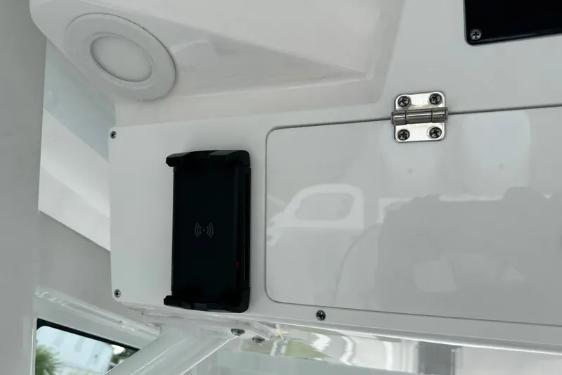 Slide: The Image of 2025 Sea Fox 288 Commander interior detail with wireless charging pad and storage compartment. - 49