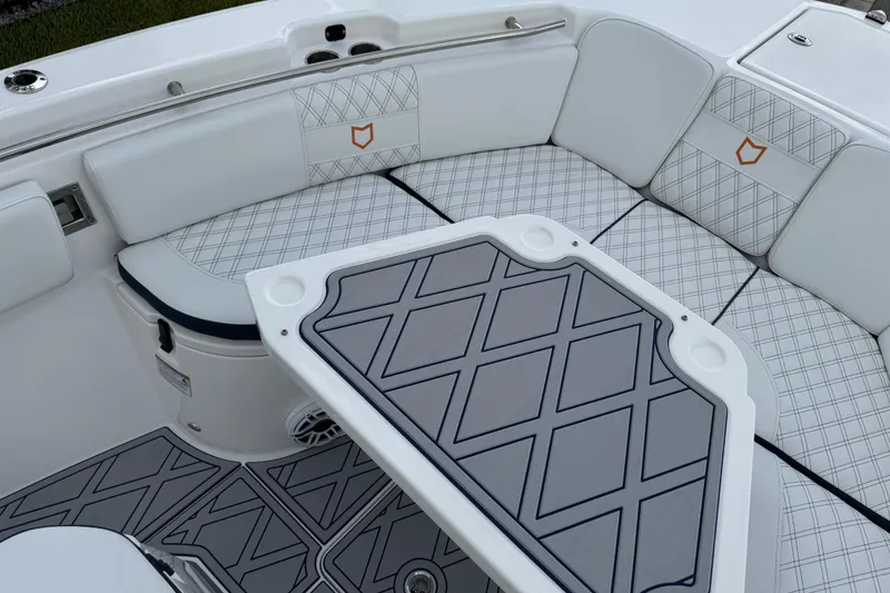 Slide: The Image of 2025 Sea Fox 288 Commander boat interior with cushioned seating and stylish table design. - 52