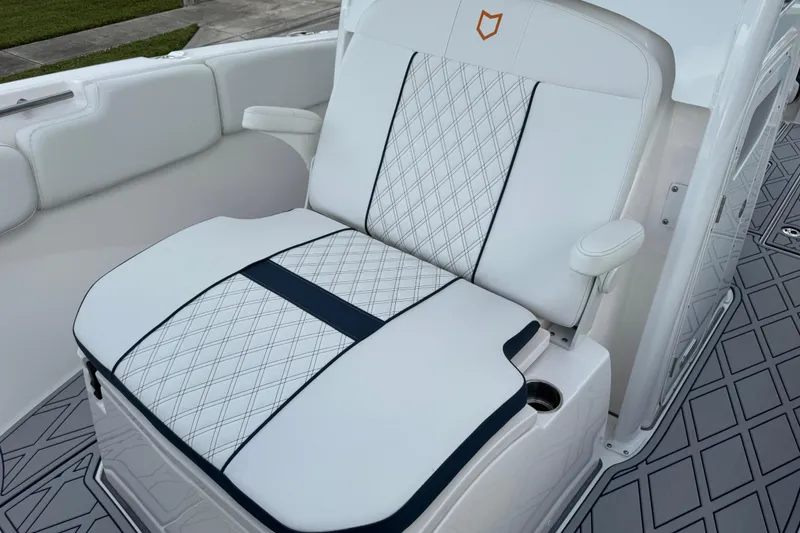 Slide: The Image of 2025 Sea Fox 288 Commander boat seat with diamond-patterned upholstery and armrests. - 60