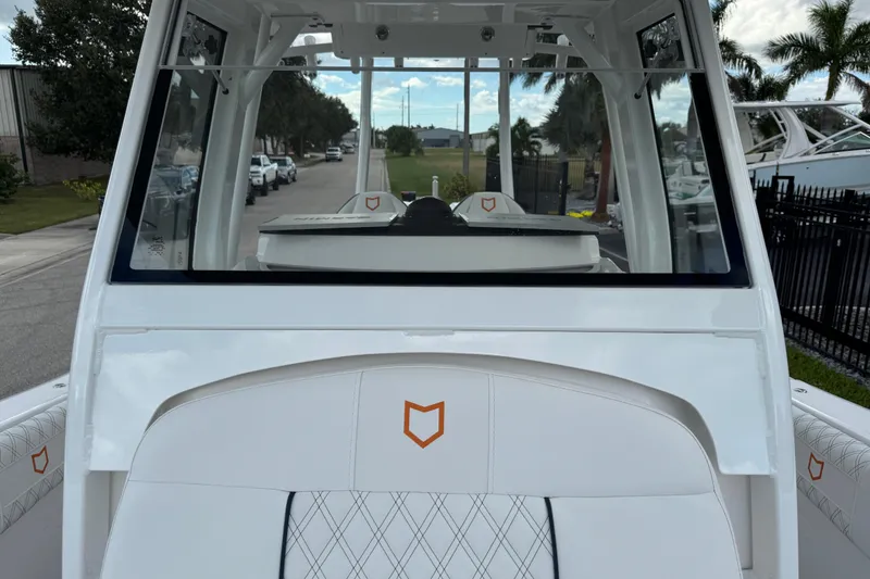 Slide: The Image of 2025 Sea Fox 288 Commander boat interior with white seating and logo. - 65