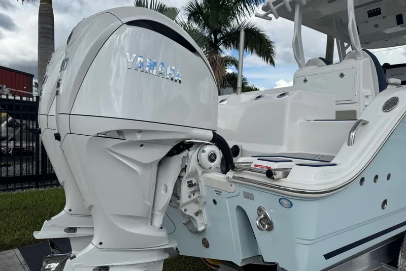 Slide: The Image of 2025 Sea Fox 288 Commander boat with Yamaha outboard motor, docked near palm trees. - 7