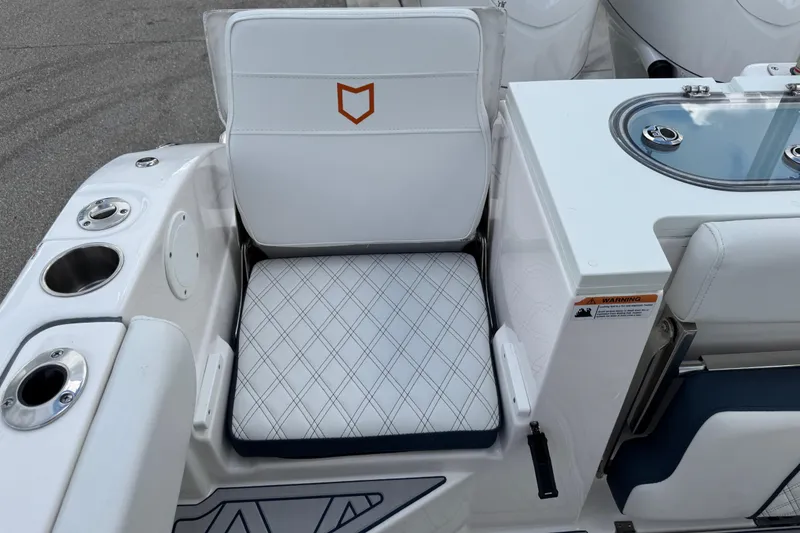 Slide: The Image of 2025 Sea Fox 288 Commander boat seat with diamond-pattern upholstery and cup holders. - 73