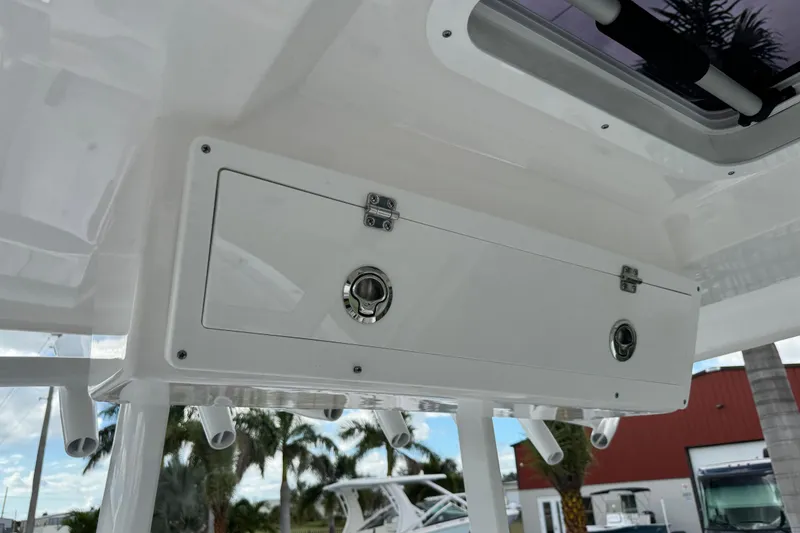 Slide: The Image of 2025 Sea Fox 288 Commander boat storage compartment with secure latches and rod holders. - 84