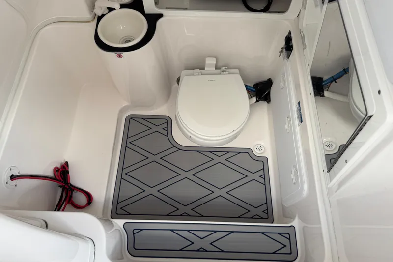 Slide: The Image of 2025 Sea Fox 288 Commander boat bathroom with toilet, sink, and storage. - 88