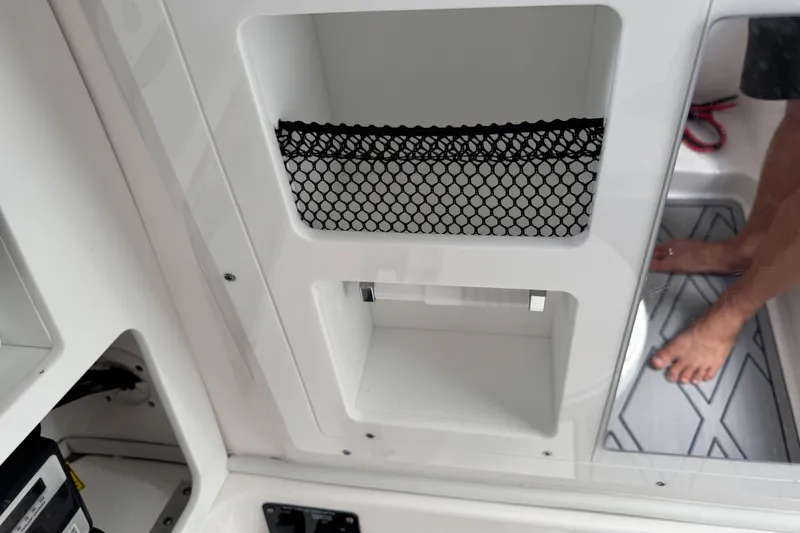 Slide: The Image of Interior storage compartment of 2025 Sea Fox 288 Commander boat with netting and footrest. - 97