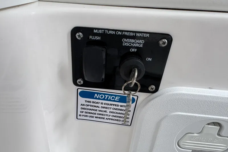 Slide: The Image of Control panel on a 2025 Sea Fox 288 Commander boat with discharge and flush options. - 98