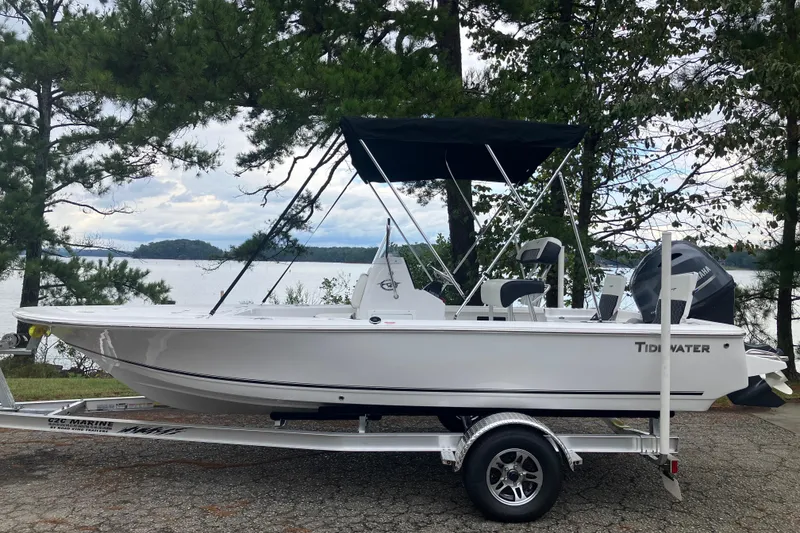 The Image of 2026 Tidewater 1910 Bay Max boat on trailer by a scenic lake. - 0