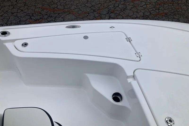 Slide: The Image of 2026 Tidewater 1910 Bay Max boat deck with storage compartment and cup holder. - 19