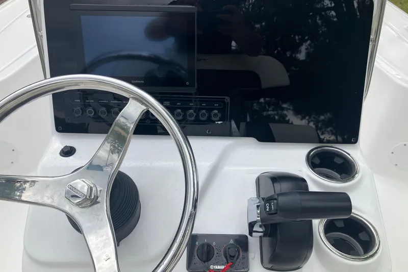 Slide: The Image of 2026 Tidewater 1910 Bay Max boat console with steering wheel, Garmin display, and controls. - 23