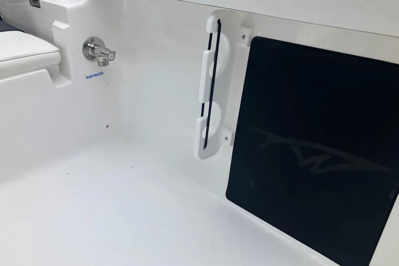 Slide: The Image of 2026 Tidewater 1910 Bay Max interior with raw water access and storage compartment. - 25