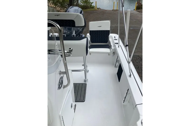 Slide: The Image of 2026 Tidewater 1910 Bay Max boat interior with seating and fishing rod holders. - 26