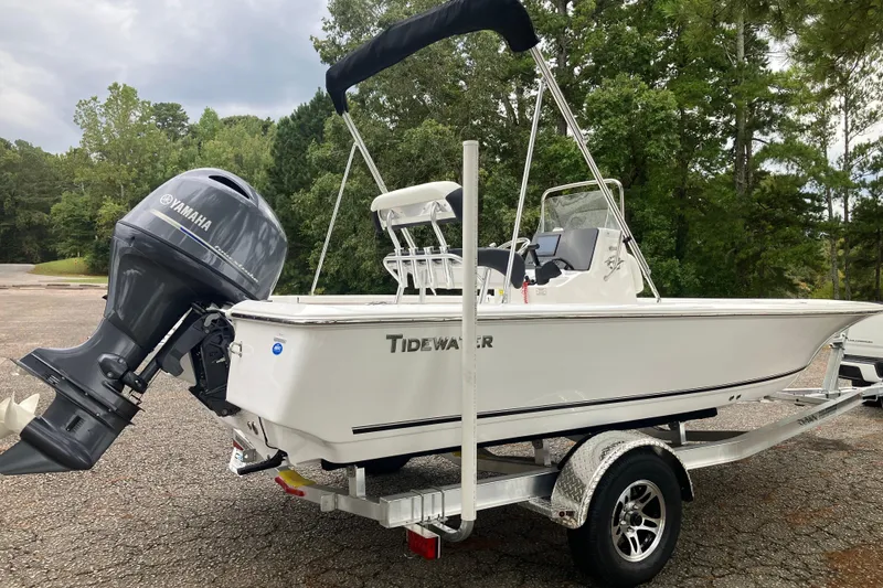 Slide: The Image of 2026 Tidewater 1910 Bay Max boat on trailer with Yamaha outboard motor, parked outdoors. - 5