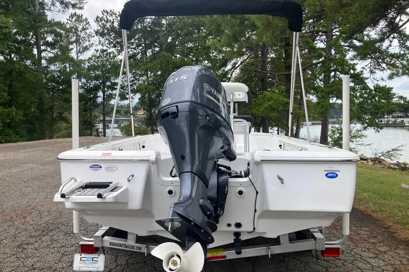 Slide: The Image of 2026 Tidewater 1910 Bay Max boat with Yamaha outboard motor, parked near a lake. - 6