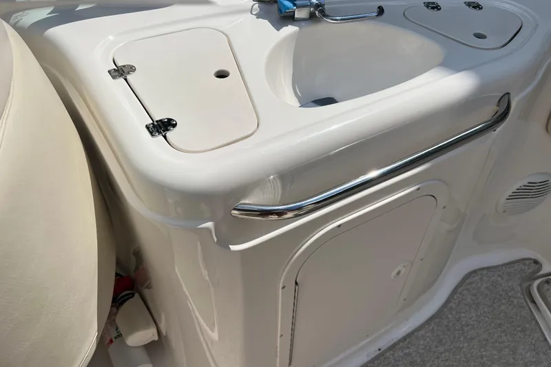 Slide: The Image of 2002 Chaparral Sunesta 243 boat interior with sink and storage compartment. - 10