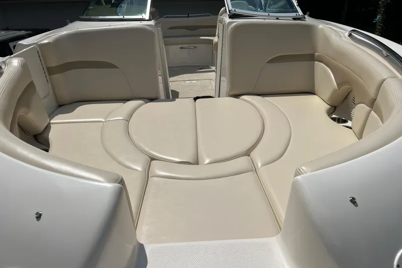 Slide: The Image of 2002 Chaparral Sunesta 243 boat interior with beige cushioned seating. - 18