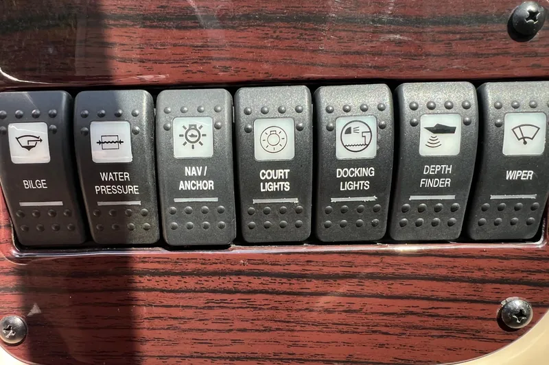 Slide: The Image of Control panel of a 2002 Chaparral Sunesta 243 boat with labeled switches. - 19