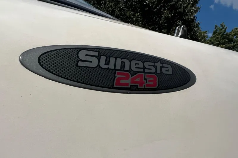 Slide: The Image of 2002 Chaparral Sunesta 243 logo on boat exterior, close-up view. - 21