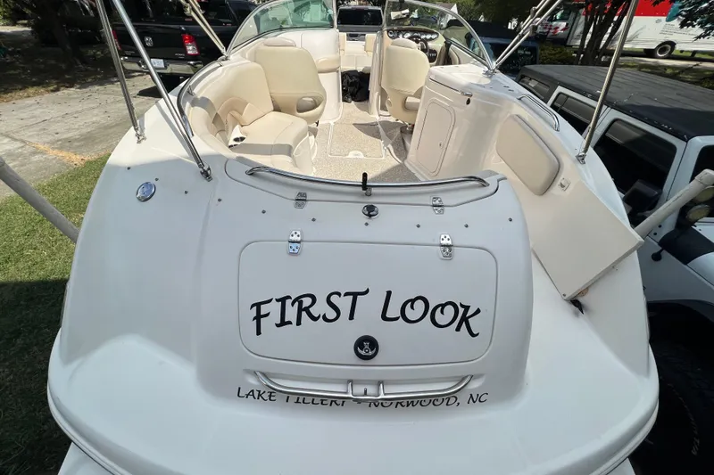 Slide: The Image of 2002 Chaparral Sunesta 243 boat, named "First Look," docked with seating area visible. - 4