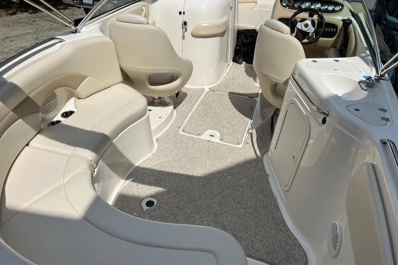 Slide: The Image of Interior of a 2002 Chaparral Sunesta 243 boat with beige seating and steering console. - 5