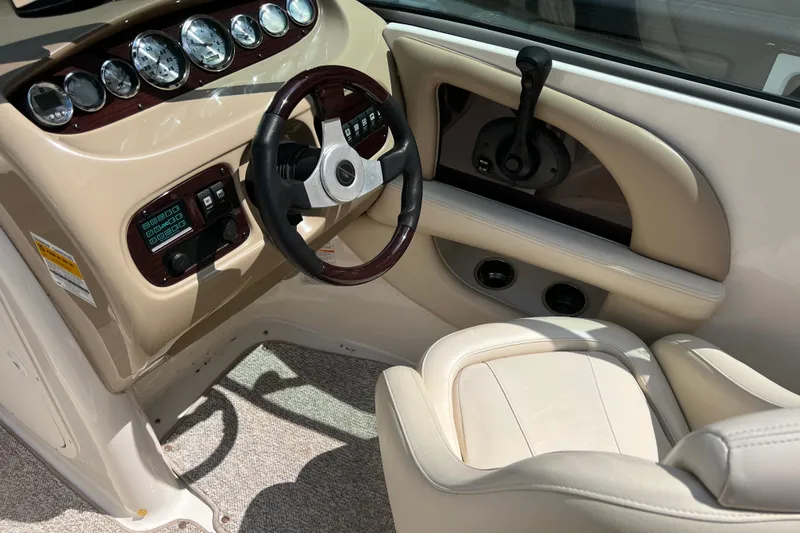 Slide: The Image of 2002 Chaparral Sunesta 243 boat interior with steering wheel and control panel. - 8