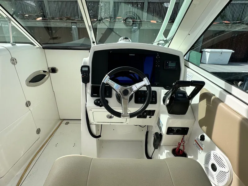 Slide: The Image of Cockpit of 2018 Sailfish 275DC boat with steering wheel and control panel. - 22