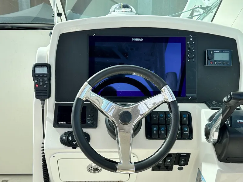 Slide: The Image of 2018 Sailfish 275DC helm with Simrad display and steering wheel. - 23
