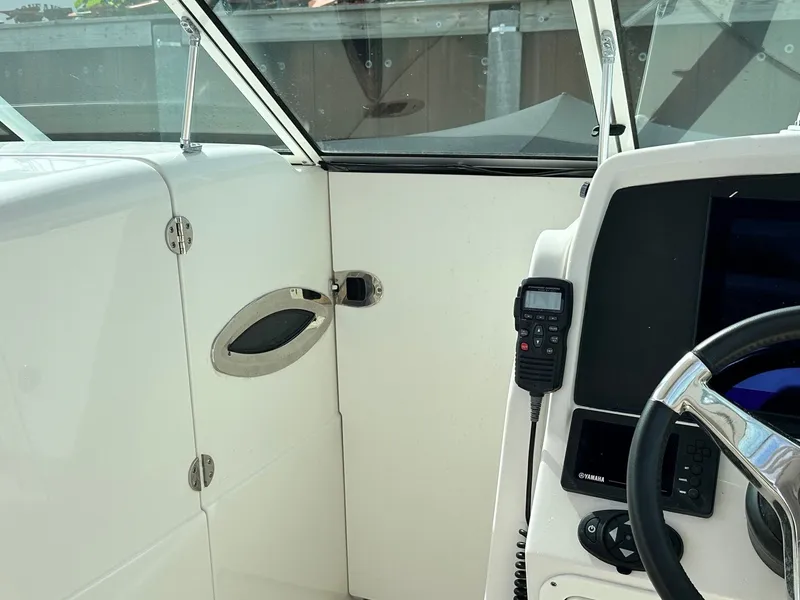 Slide: The Image of 2018 Sailfish 275DC boat cockpit with steering wheel and control panel. - 24