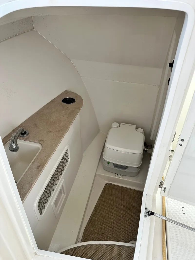 Slide: The Image of Compact bathroom in 2018 Sailfish 275DC boat with sink and portable toilet. - 30