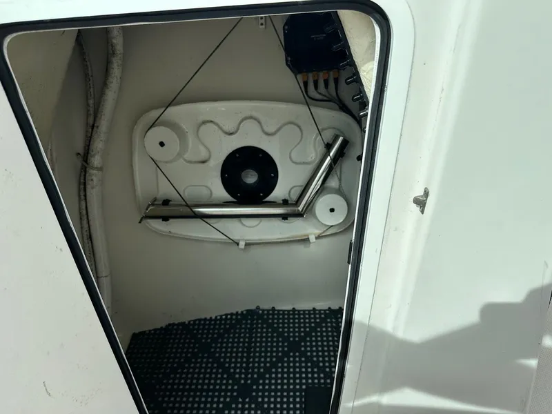 Slide: The Image of 2018 Sailfish 275DC storage compartment with mechanical components and wiring. - 32