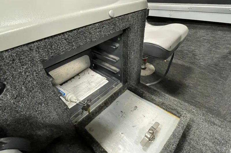 Slide: The Image of Interior storage compartment of a 1994 Alumacraft Classic 165 CS boat. - 16