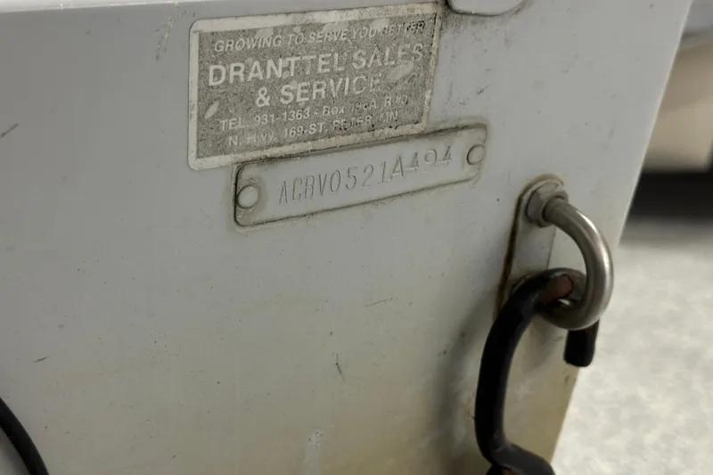 Slide: The Image of Close-up of a 1994 Alumacraft Classic 165 CS boat identification plate and hook. - 17