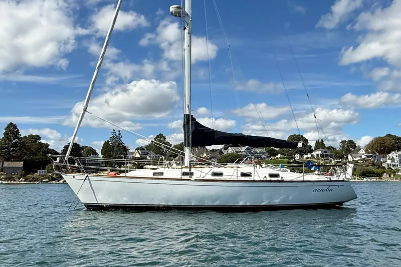The Image of Sailboat Tartan 3800, 1997 model, anchored on a sunny day with scenic background. - 0