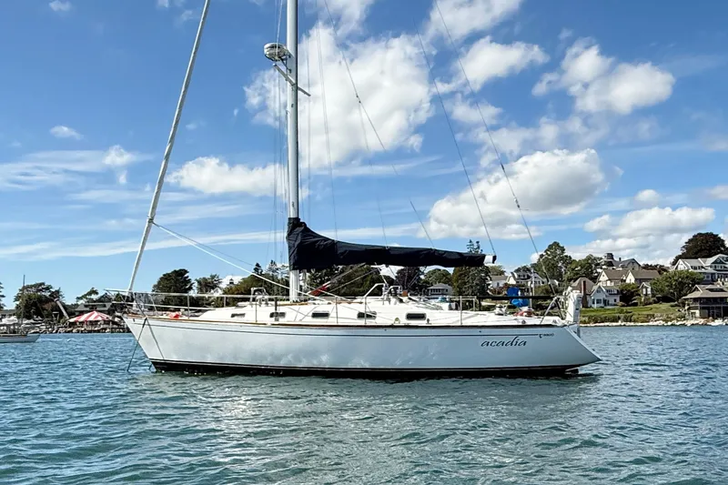 Slide: The Image of Sailboat Tartan 3800, 1997 model, anchored on a sunny day with blue skies. - 1