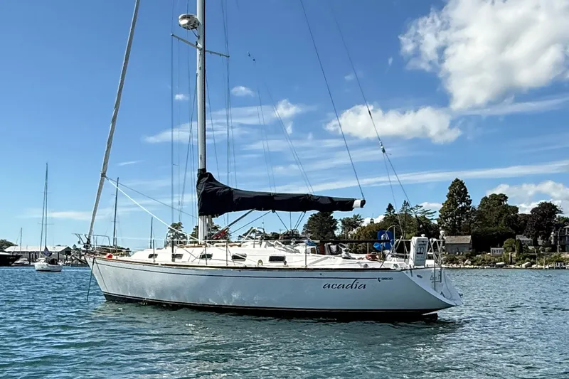 Slide: The Image of Sailboat Tartan 3800, 1997 model, anchored on a sunny day with blue skies. - 12
