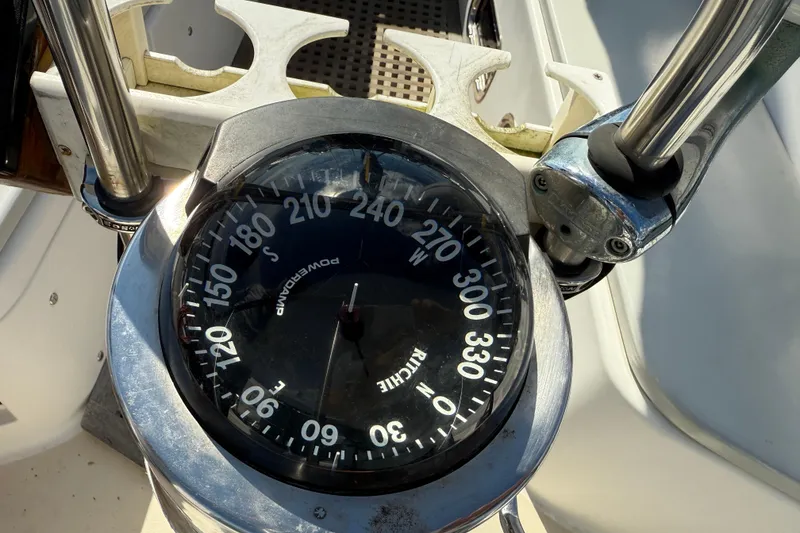 Slide: The Image of Close-up of a 1997 Tartan 3800 boat compass, showing directional degrees. - 16