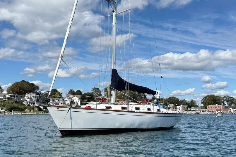 Slide: The Image of Sailboat Tartan 3800, 1997 model, anchored in scenic harbor with blue sky. - 2