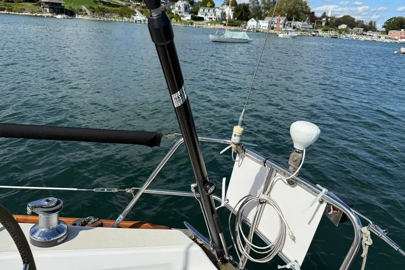 Slide: The Image of Sailboat deck view on water, Tartan 3800, 1997 model, with coastal background. - 26