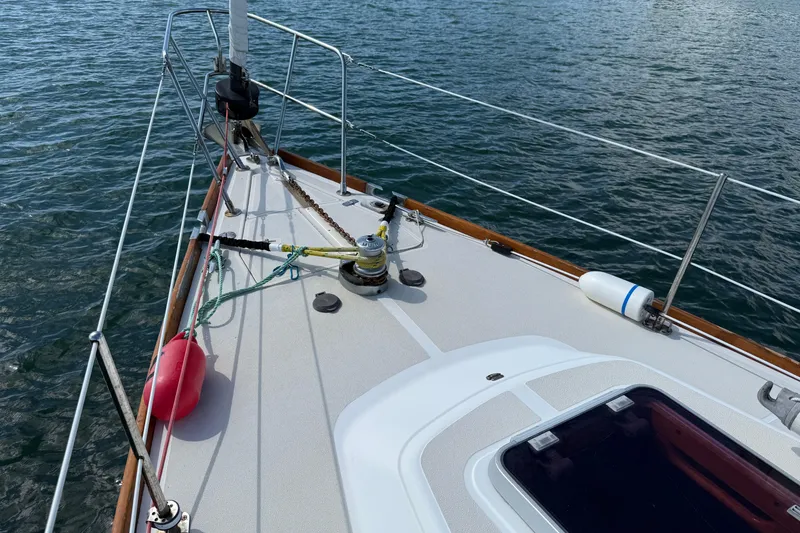 Slide: The Image of Deck of 1997 Tartan 3800 sailboat with winch and ropes on calm water. - 33