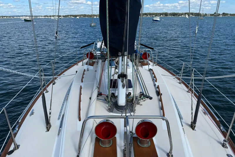 Slide: The Image of Sailboat deck view of 1997 Tartan 3800 on calm waters under blue sky. - 35